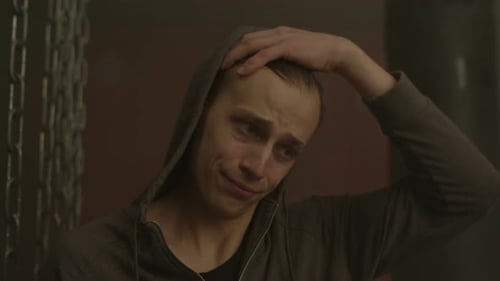 Upset Man Removing Hood, Displaying Emotions