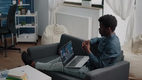 Man Using Laptop for Video Call at Home