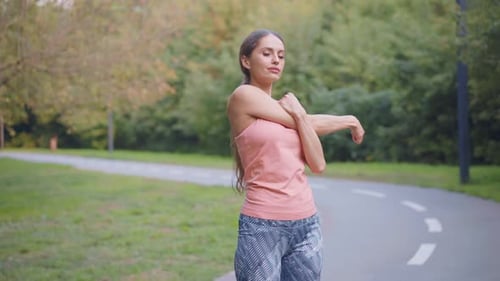 Woman Runner Stretching Arms Before Running Summer Park