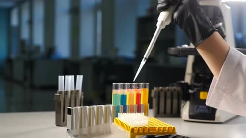 Close-up Shot of Female Hand of Researcher in Glove Using Micro Pipette While Working with Test