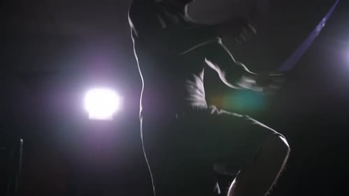 Man Exercising by Jumping Rope in Gym