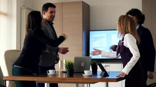 Corporate Team Meets for Business Meeting at Table