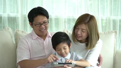 Happy Family Using Tablet Together at Home