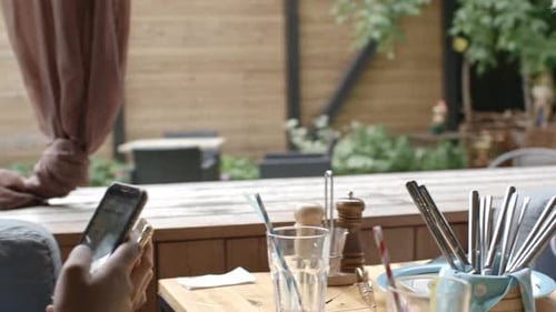 Girls Checking Social Media Sites in Cafe