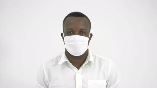 Young Man Smiling After Removing Face Mask