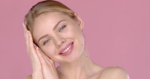 Beautiful Woman Smiling with Hands on Face