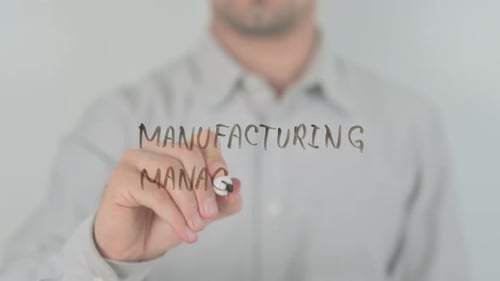 Man Writes Manufacturing Management on Clear Surface
