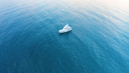 Luxury Yacht Sailing Across Calm Turquoise Ocean
