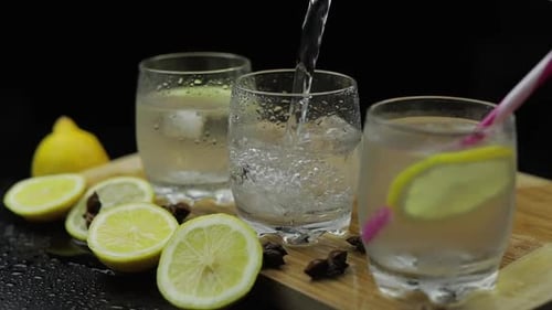 Refreshing Lemon Water Being Poured into Glass