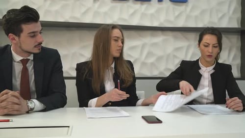 Businesswomen signing a document