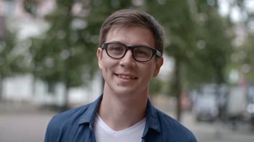 Young Man in Eyeglasses Smiling at Camera