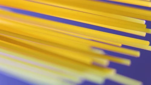 Close Up of Raw Unprepared Spaghetti Rotating on Blue Background
