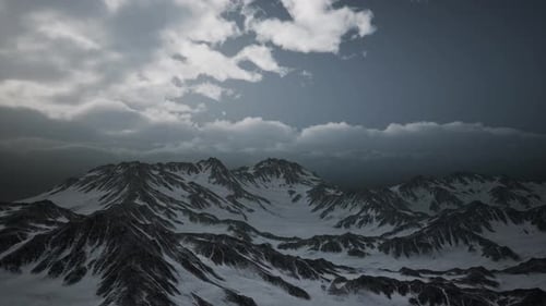Snowy Mountain Range Aerial View with Dramatic Clouds