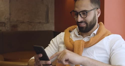 Man Using Smartphone in Urban Indoor Setting