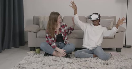 Women Enjoying Virtual Reality Gaming at Home
