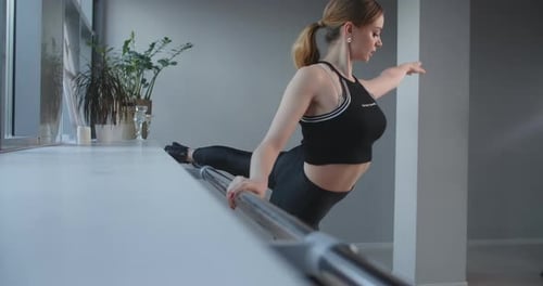 Attractive Young Woman Stretches and Practice Near the Ballet Machine in the Dance Hall, Sexy Female