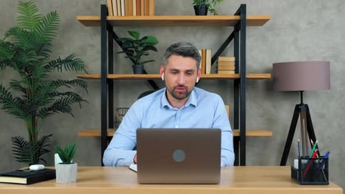Adult Man Talking on Laptop Video Call