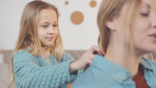 Daughter Brushing Hair of Her Mom