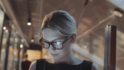 Young Blonde Businesswoman Using Smartphone in Office