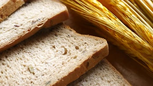 Whole Wheat Bread Slices Next to Dried Wheat
