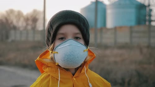 Child Girl in Protective Mask on Industrial Plant Smoke Background. Atmospheric Pollution and People