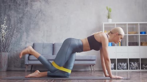 Woman Exercising with Resistance Band in Home