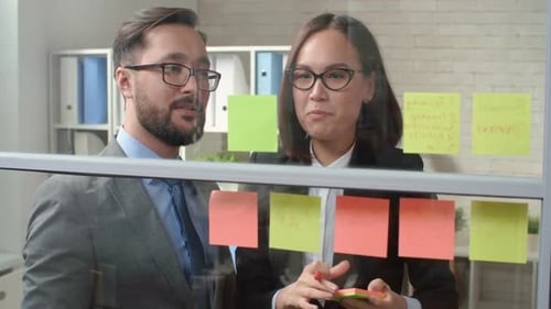 Business People Collaborating with Notes in Modern Office