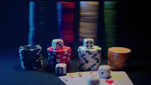 Casino Chips with Dice and Playing Cards on a Dark Table