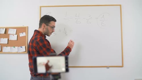 Young Teacher Teaching Online Using Smartphone Camera To Stream Lesson