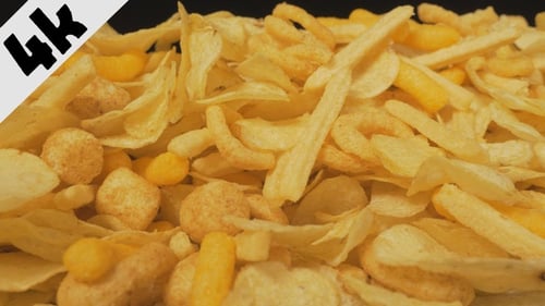 Variety of Chips Pile on Black Background