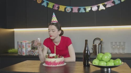 Sad Woman in Cone Hat Celebrating Birthday Alone