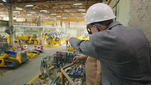 Multiethnic Engineers Discussing Manufacturing Process in Factory
