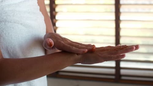 Woman Applies Exfoliating Scrub To Hands