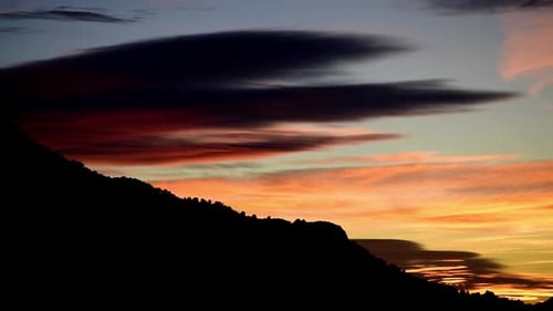 Mountainside Silhouetted Against Fiery Sunset