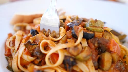 Spaghetti In Tomato Sauce On A Plate With A Fork