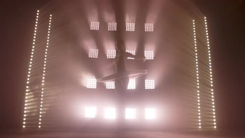 Ballet Dancer Performing Elegant Dance with Bright Lights