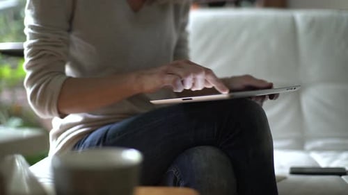 Adult Using Tablet Device at Home