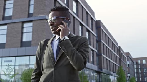 African Office Worker Talking on Phone Outdoors