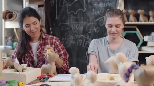 Two Women Creating Paper Mache Sculptures Together