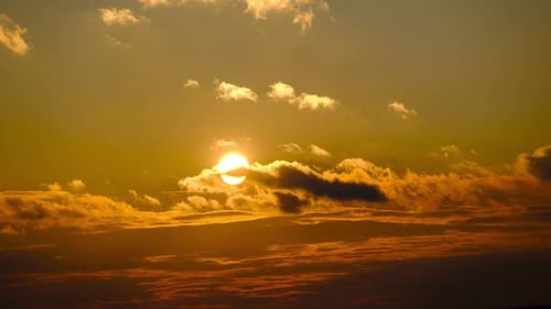 Vivid Sun Sinking Below the Clouds at Sunset