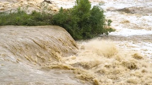 Dirty river with muddy water in flooding period during heavy rains in spring.