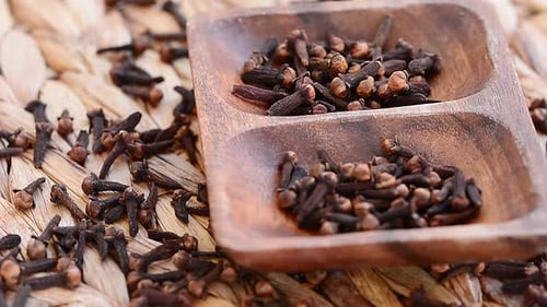Aromatic Cloves in Wooden Dish, Close Up