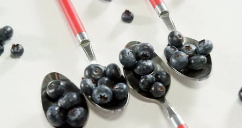 Ripe Blueberries in Spoons