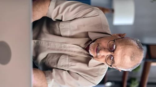 Senior Man Working on Laptop Computer Indoors