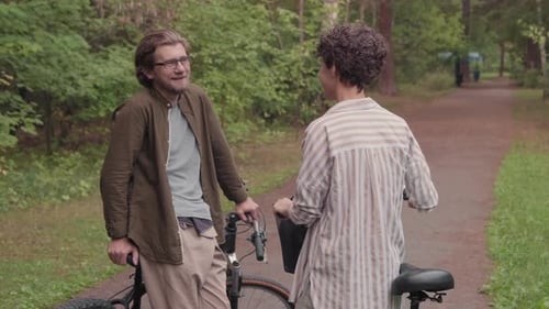 Chatting Couple In Forest With Bikes