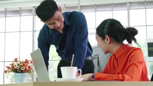 Two Business People Talk Project Strategy at Office