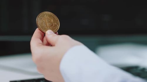 Close Up of Male Hand Holding Bitcoin