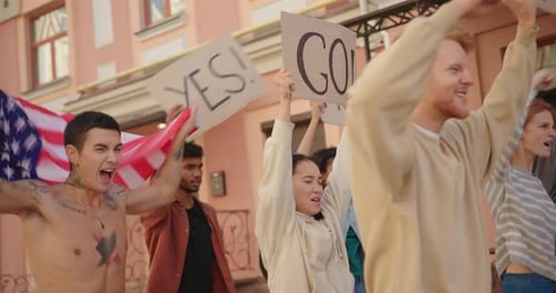 Protest March at City Street with Slogans on Posters Side View