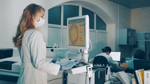 Woman Operates Computer System Linked to Medical Equipment