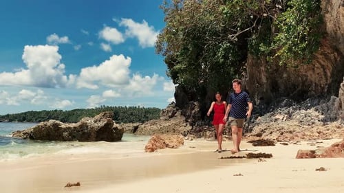 Happy Interracial Couple Walking on the White Sand Beach Shore at Summer Day.
